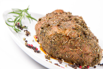 Raw pork loin seasoned - ready to be roasted, on a plate	
