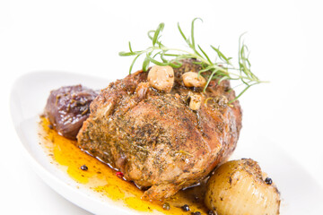 Roast pork loin with onions and garlic, decorated with rosemary and some colorful peppercorns