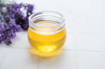 Jar with honey and fresh lavender flowers