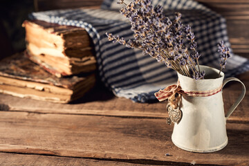 Still life of tiny creamer and lavender flowers on a rustic wooden background, Provence feel
