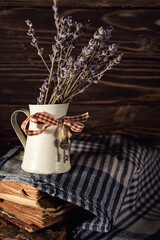 Still life of tiny creamer and lavender flowers on a rustic wooden background, Provence feel