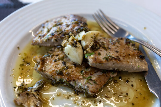 Grilled tuna steak in herb garlic and lemon marinade