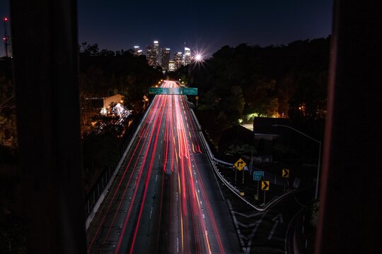 Drone Long Exposure Shot Over Car Lights In Downtown Los Angeles With Trees At Night