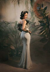 Sexy back, elegant woman in twenties old style mermaid silhouette silver retro long evening dress...