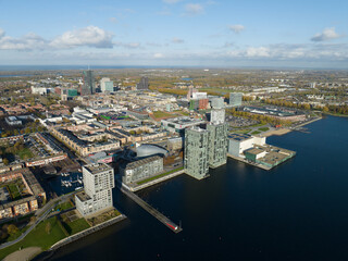 Fototapeta na wymiar Almere medium large dutch city in province of Flevoland, The Netherlands, Skyline downtown city center, Almere Stad center, city build below sea level, Infrastructure and urban aerial view.