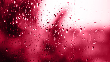 Viva Meganta toned red magenta macro shot falling rain water drops bubbles on wet window glass...