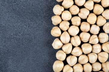 Peeled hazelnuts on black background