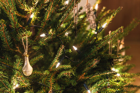 Close-up of christmas tree with decorations and fairy lights