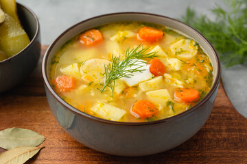 Cucumber soup - traditional Polish soup with pickled cucumbers, potatoes, carrots and dill