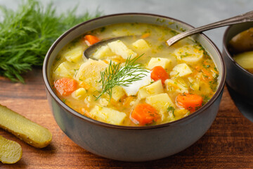 Cucumber soup - traditional Polish soup with pickled cucumbers, potatoes, carrots and dill