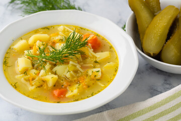 Cucumber soup - traditional Polish soup with pickled cucumbers, potatoes, carrots and dill