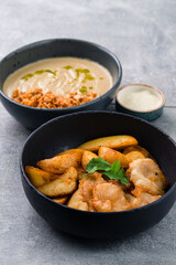 Lunch mushroom cream soup and fish with chips, cilantro and spices.