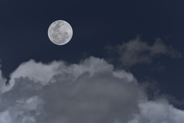 Full moon with clouds in the sky.