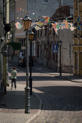 CITYSCAPE - Stylish street lamp, old picturesque tenement houses in the sunlight