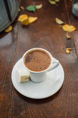 Turkish coffee on a wooden table and fallen autumn leaves. Turkish coffee in the cup. traditional turkish coffee 