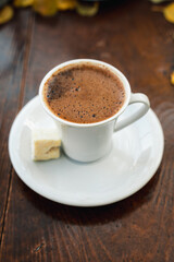 Turkish coffee on a wooden table and fallen autumn leaves. Turkish coffee in the cup. traditional turkish coffee 