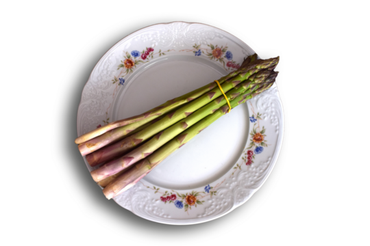 Espárragos verdes en un plato blanco. 