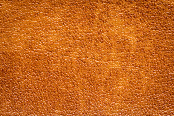 Brown artificial or synthetic leather background with neat texture and copy space
