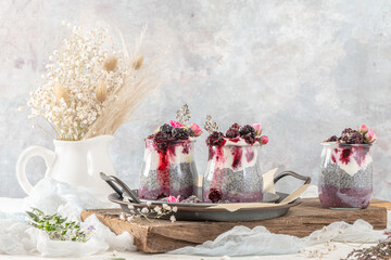 Chia pudding with blackberries and jam in glass jars. Concept of healthy eating, healthy lifestyle, dieting, fitness menu