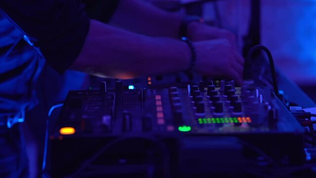 Dj mixer controller on disco party, party lover touching buttons and sliders, mixing music sounds. Professional deejay creating disco atmosphere working with dj mixer controller, disco party with