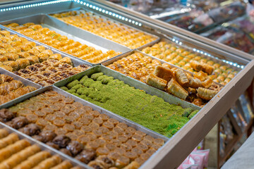 Traditional Turkish dessert baklawa in different flavors and styles in the Egyptian bazaar in Istanbul. Dessert shop at grand bazar baklava ramadan