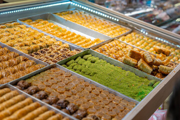 Traditional Turkish dessert baklawa in different flavors and styles in the Egyptian bazaar in Istanbul. Dessert shop at grand bazar baklava ramadan