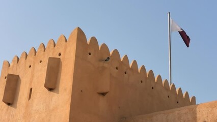 Al Zubara Fort in the northern part of Qatar. The entrance of the former castle, a historic military fortification in the Arabian Peninsula, is set in the arid desert landscape near the Persian Gulf.