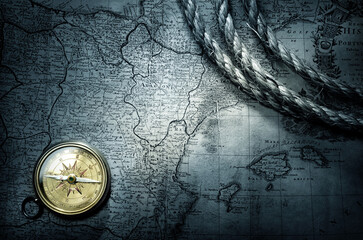 Obraz na płótnie Canvas Magnetic old compass on world map. Travel, history, geography, navigation, tourism and exploration concept background.