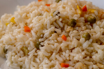 bowl with delicious rice and vegetables on black background, top view