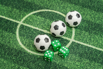 dice and soccer ball on green grass, football sports betting concept