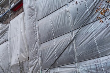Building covered with a tarpaulin