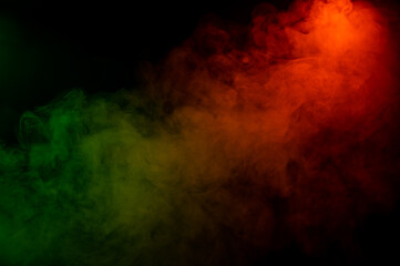 Red yellow green smoke on a black background.