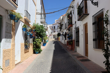 Fototapeta na wymiar Picturesque street decorated with pots in Estepona (Malaga)