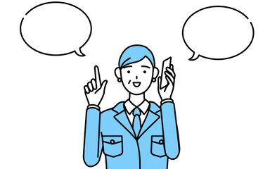 電話をしながら指さしをする作業着を着たシニア女性（経営者、管理職、工場長）