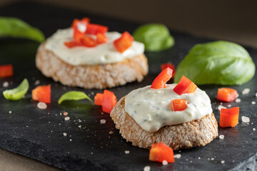 Pieces of toast with tasty cream cheese and bell pepper pieces