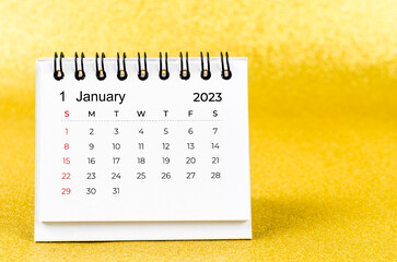 The January 2023 Monthly desk calendar for 2023 year on golden color background.