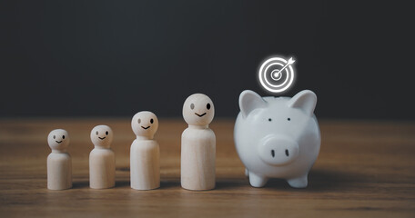 Wooden peg doll, white piggy bank and stack of coins to saving money budget, financial and banking...