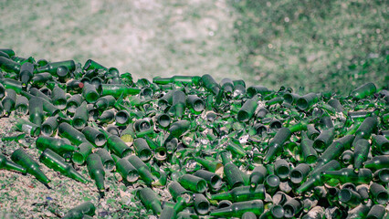 Green glass bottles in the trash