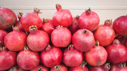 Heap of pomegranate fruits on showcase of market