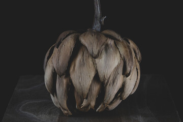 Dried artichoke isolated on black background