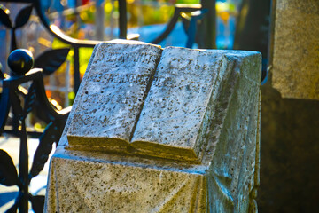 old tombstone in shape of an open book