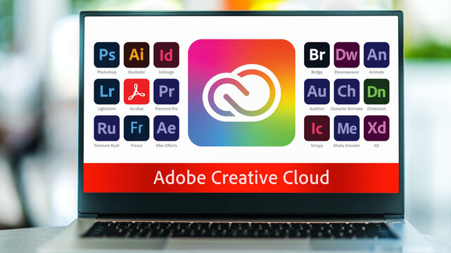 Laptop computer displaying logotypes of Adobe Creative Cloud