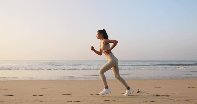 Female Runner Jogging During Outdoor Workout on the Beach in Slow