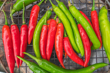 Red and green chili grill on stove for prepare a cook of spicy food. Food and vegetable background