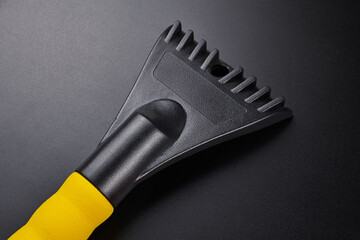 Car scraper brush to clean snow from windshield, remove ice isolated on black background