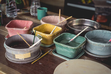 Jars with acrylic paints at a workshop