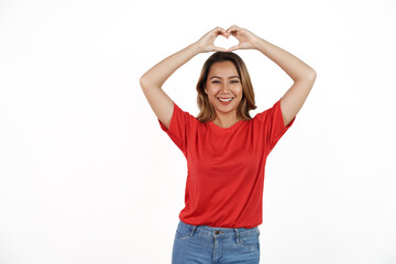 Studio shot of pretty Asian woman with red t-shirt isolated on white background. Heart shape