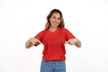 Obraz na płótnie Canvas Studio shot of pretty Asian woman with red t-shirt isolated on white background. Two hands pointing