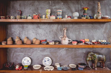 Fototapeta na wymiar Ceramic toys on the shelves for sale at the workshop