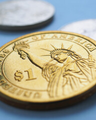 American coin lies on blue surface. One dollar coin close up. Statue of Liberty. USA economy and money. Vertical stories about inflation and Fed rate. US public debt and treasury. Macro